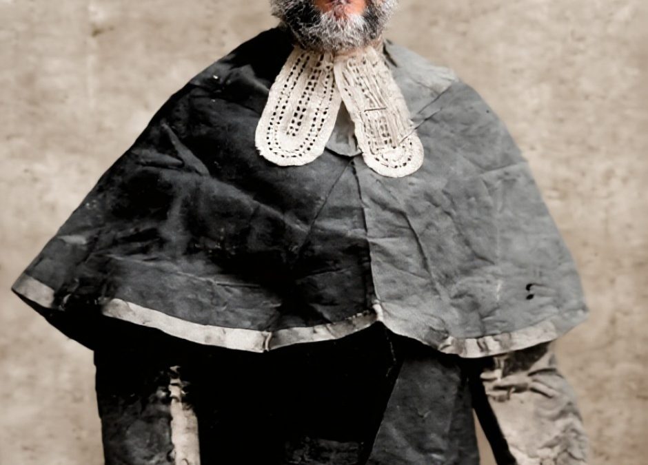 Colourised portrait of Badruddin Tyabji in a judge's wig and robes, holding a scroll