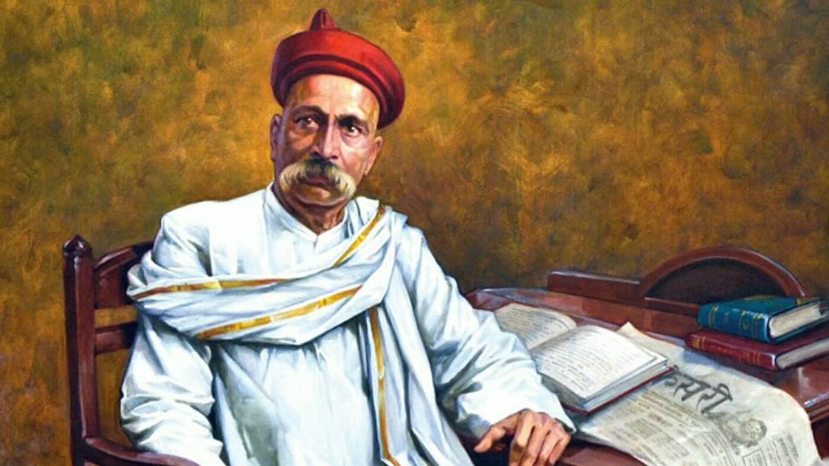 Painted portrait of Bal Gangadhar Tilak in a red turban seated at a desk with books and a newspaper