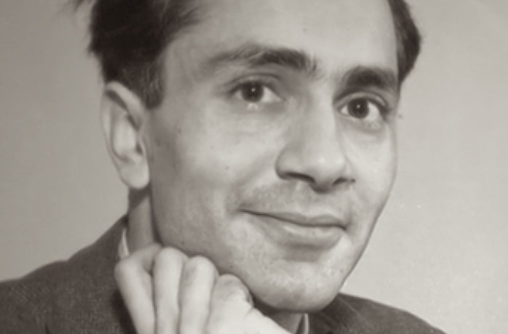 A black-and-white portrait of the young Balraj Sahni resting his chin on his hand