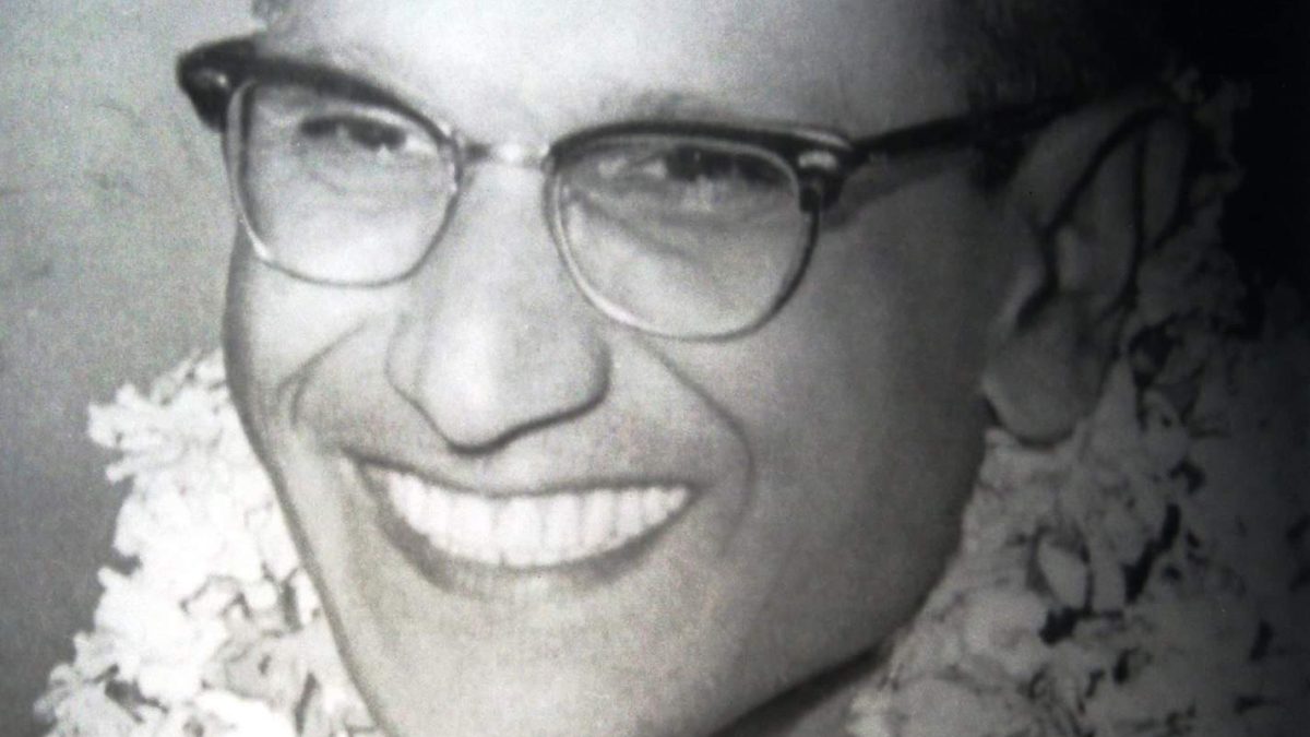 Batukeshwar Dutt in glasses, smiling, with flower garlands around his neck