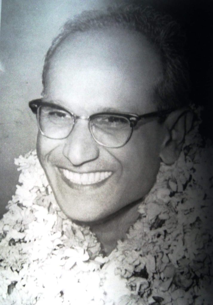 Batukeshwar Dutt in glasses, smiling, with flower garlands around his neck