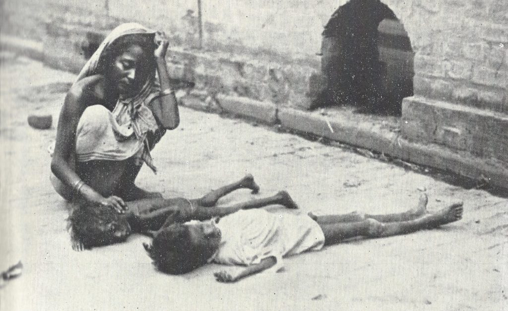 A woman with two starving children on a street in Calcutta