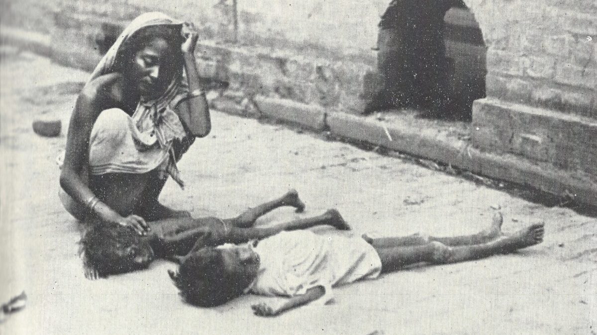 A woman with two starving children on a street in Calcutta