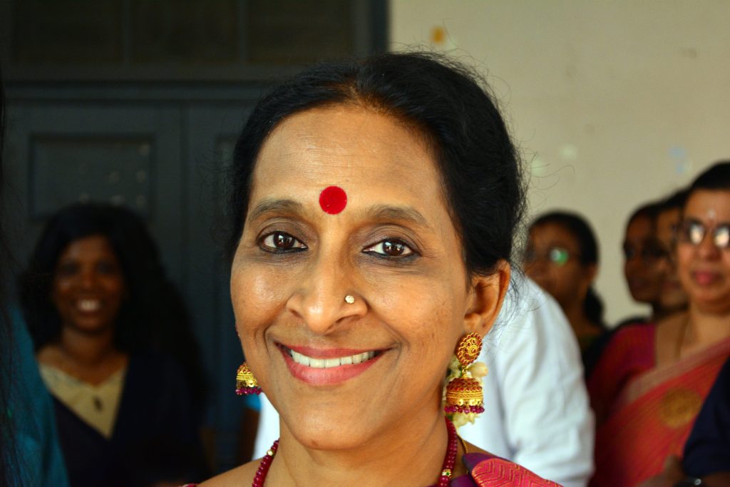 Close-up of Bombay Jayashri smiling, wearing a red bindi