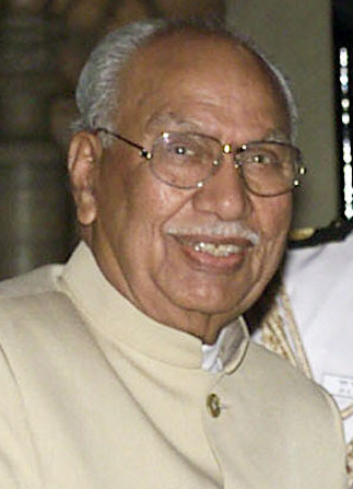Brijmohan Lall Munjal in glasses and a cream bandhgala, smiling