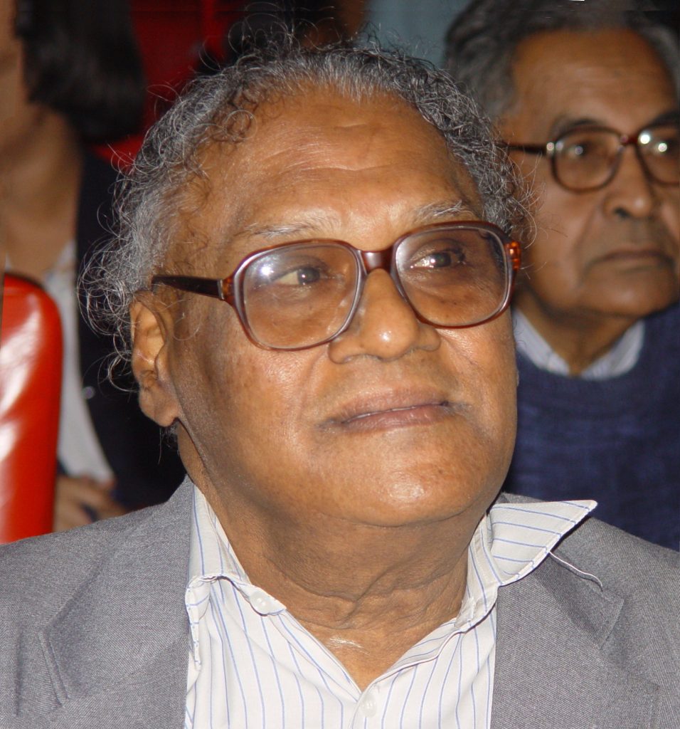 C. N. R. Rao in glasses and a grey jacket, smiling