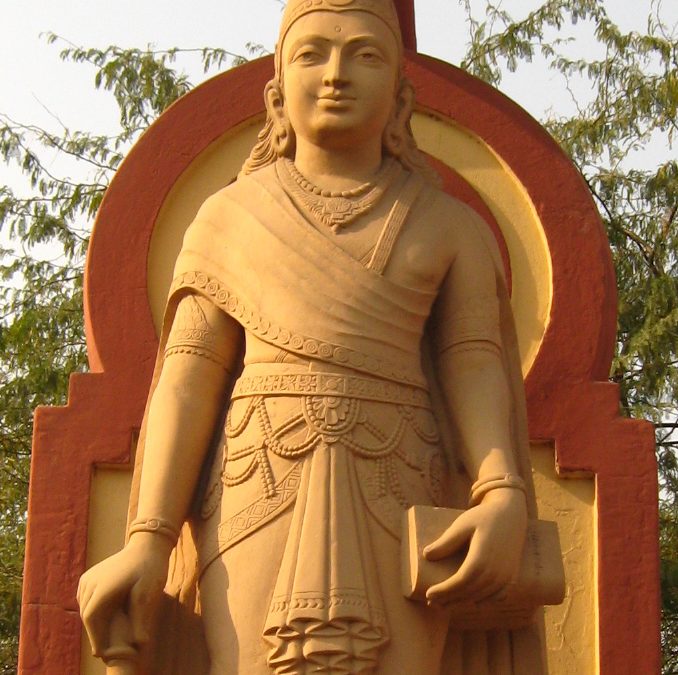 A sandstone statue of the young Chandragupta Maurya standing with a staff