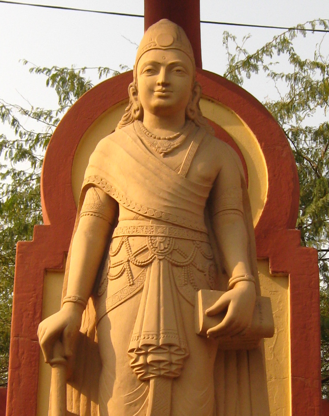 A sandstone statue of the young Chandragupta Maurya standing with a staff