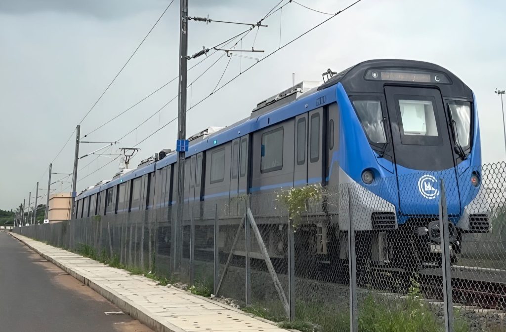 A blue Chennai Metro Rail phase II train on an elevated track