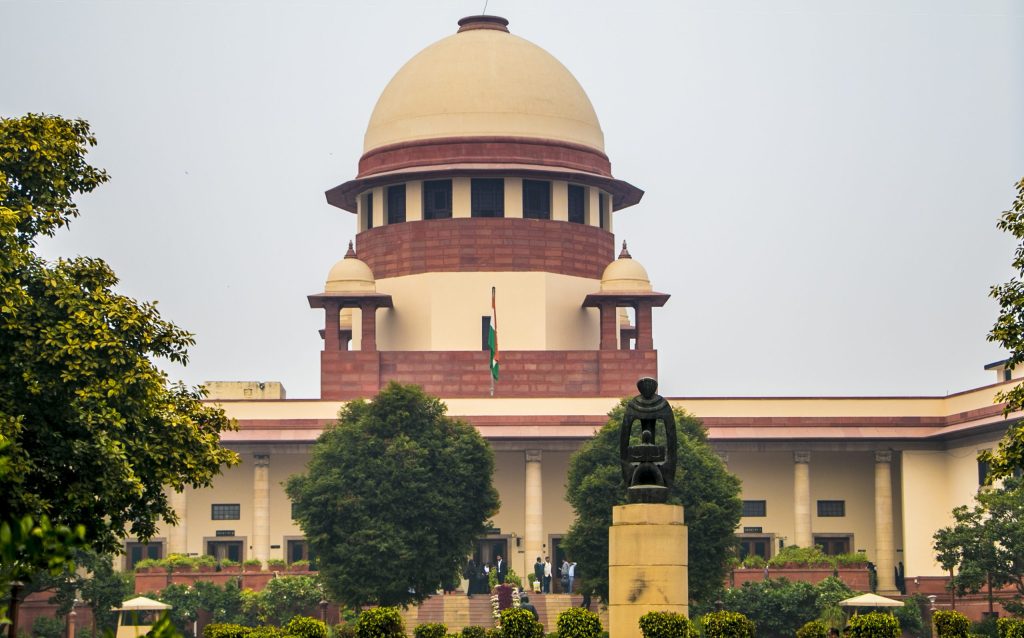 The dome of the Supreme Court of India building in New Delhi behind trees