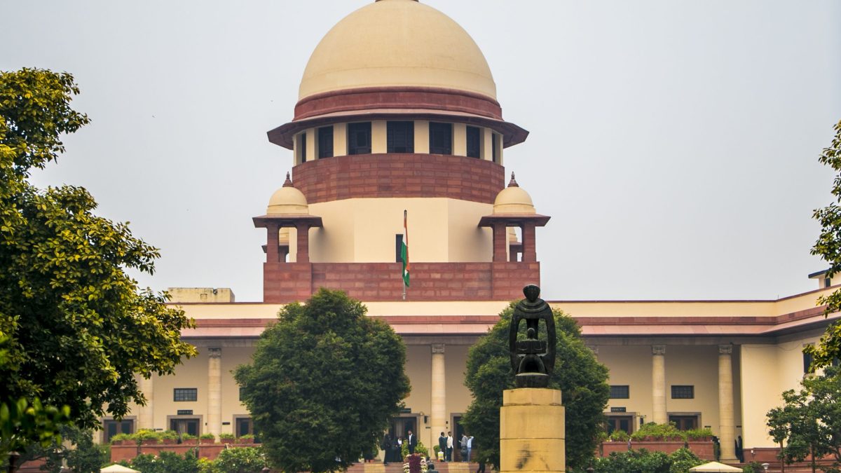 The dome of the Supreme Court of India building in New Delhi behind trees
