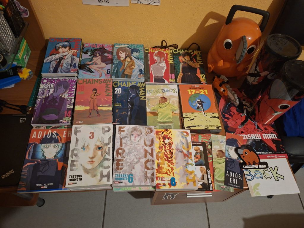 A collection of manga volumes laid out on a floor