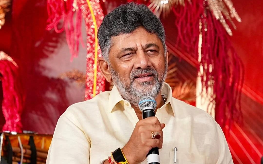 D. K. Shivakumar speaking into a microphone