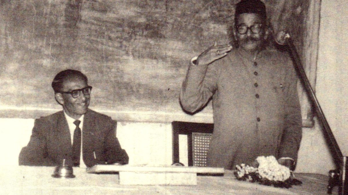 A black-and-white photograph of D. R. Bendre and H. S. Krishnaswamy Iyengar at a table during a function