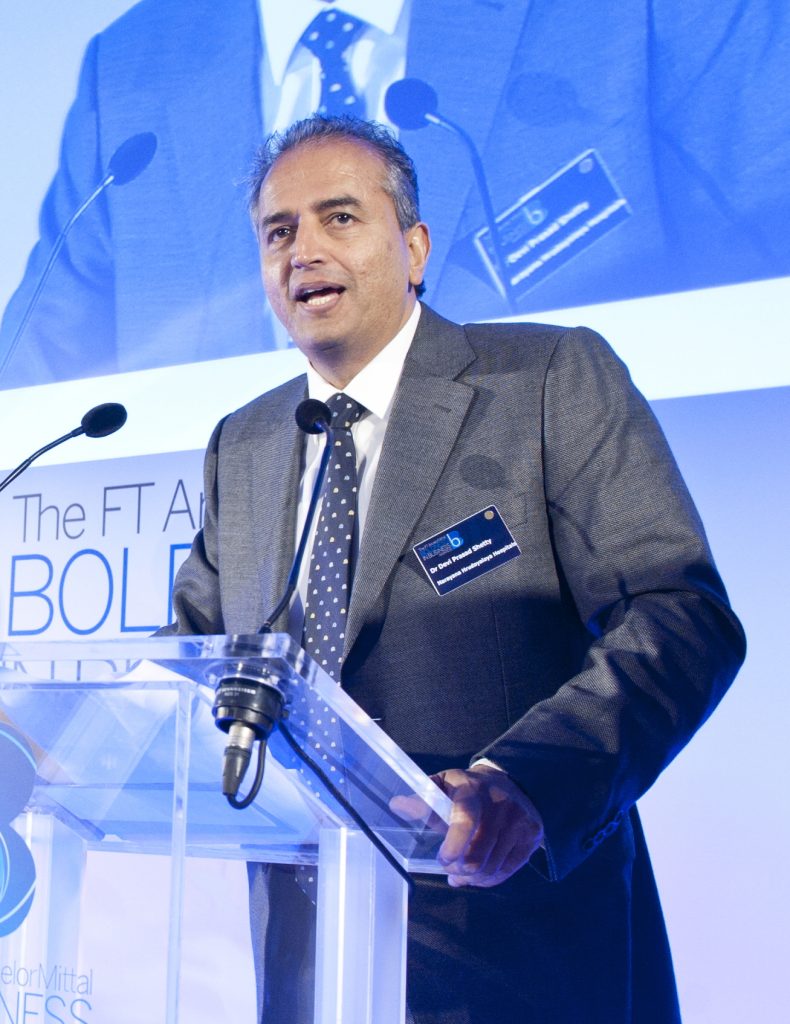Devi Shetty in a suit at an awards event