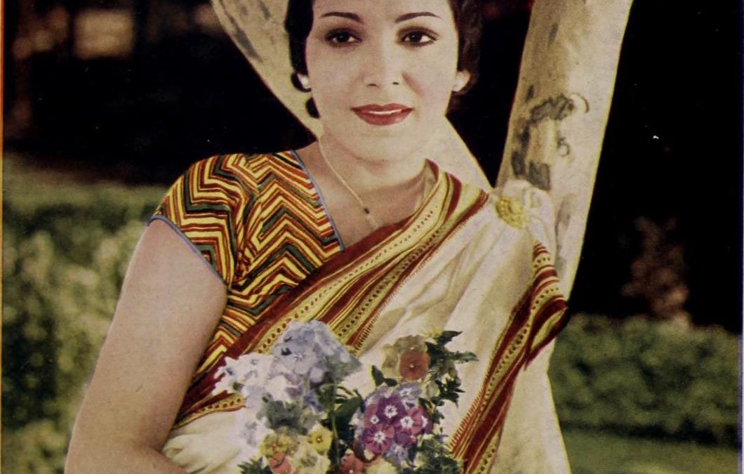 Devika Rani in a sari holding flowers