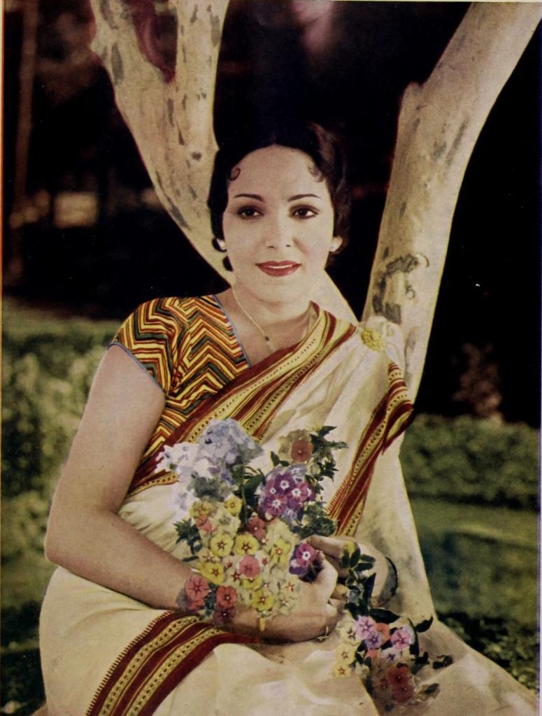 Devika Rani in a sari holding flowers