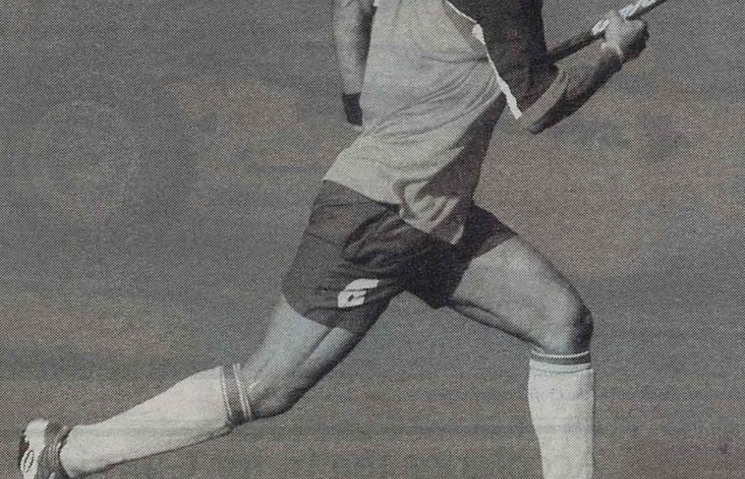Dhanraj Pillay running with a hockey stick during a match
