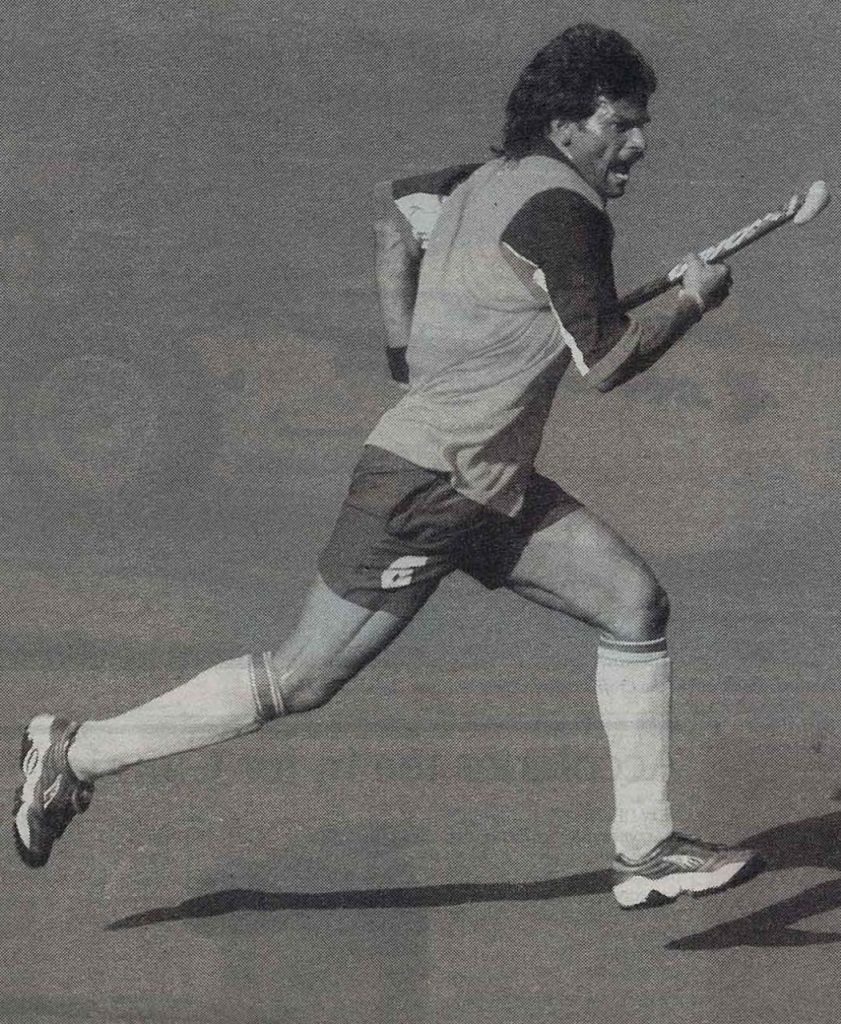 Dhanraj Pillay running with a hockey stick during a match