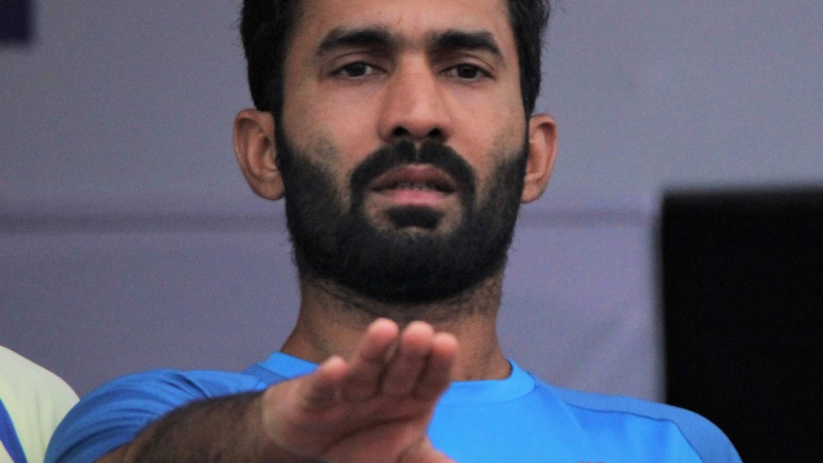 Dinesh Karthik with a beard in a blue India training jersey