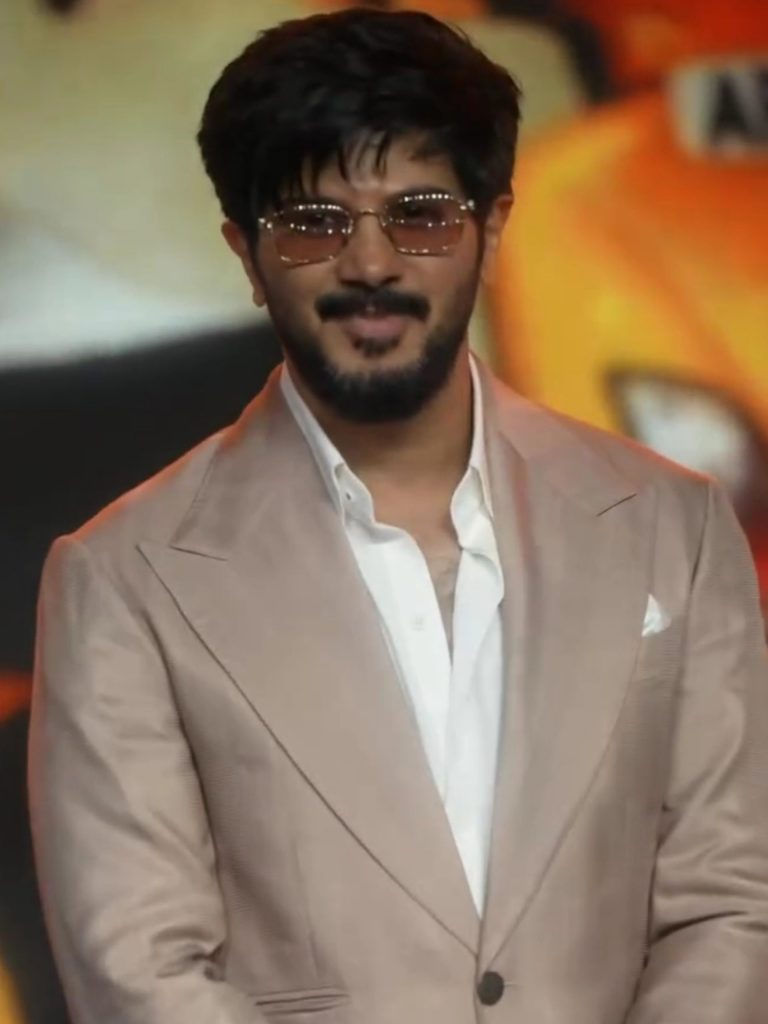 Dulquer Salmaan in tinted glasses and a beige suit