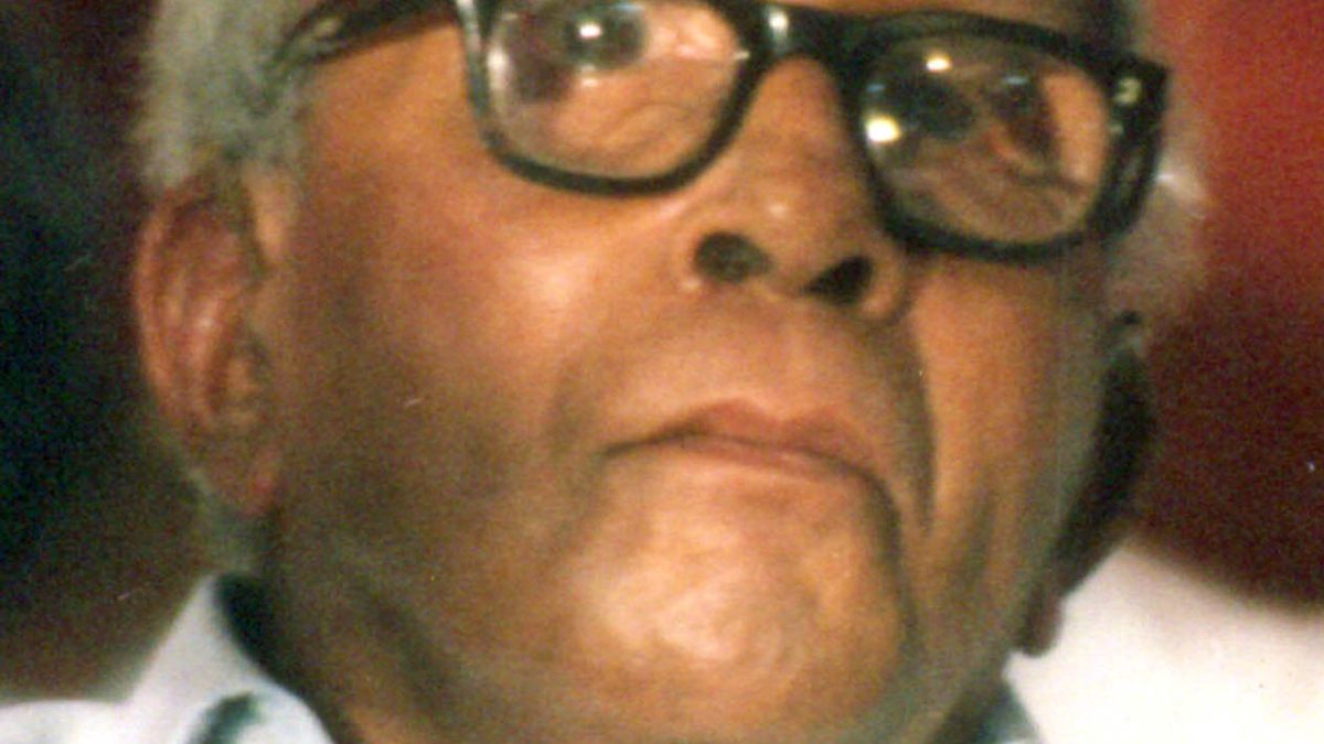 Close-up of E. M. S. Namboodiripad in thick black-framed glasses and a white shirt