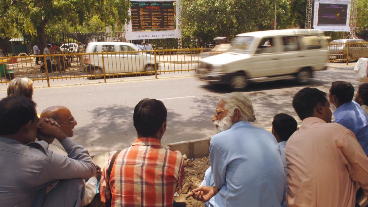 People watching a results display board outside the Election Commission of India office in New Delhi