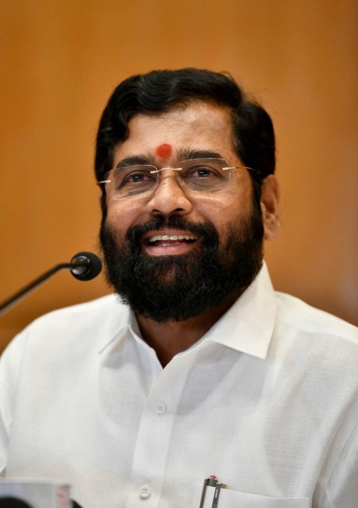 Eknath Shinde with a beard, in a white shirt, with a tilak on his forehead
