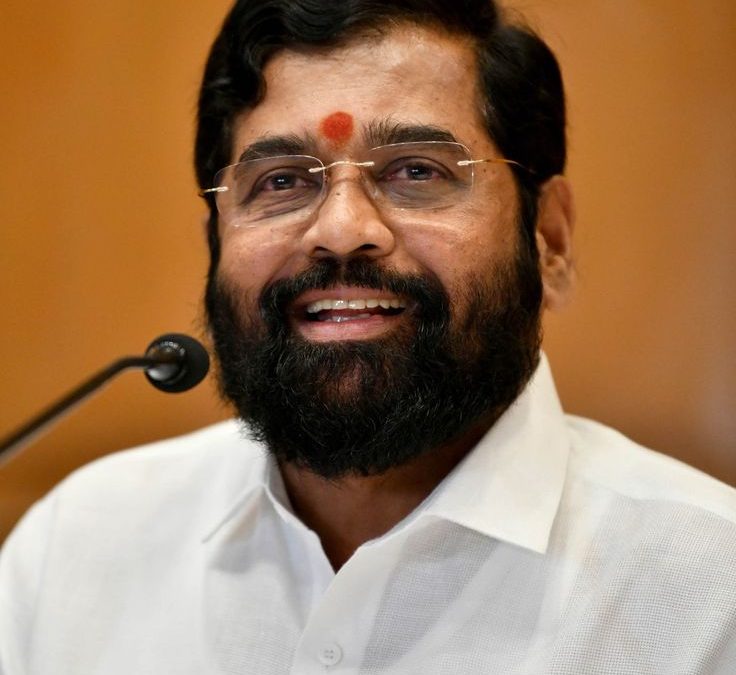 Eknath Shinde with a beard, in a white shirt, with a tilak on his forehead