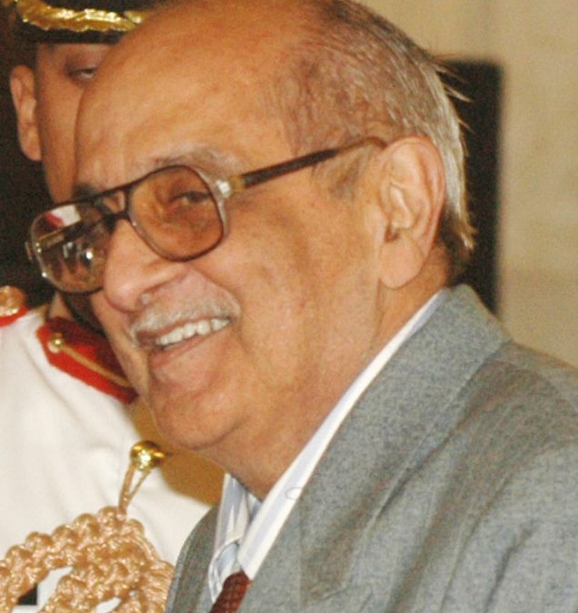 Fali Nariman in glasses and a grey suit, smiling