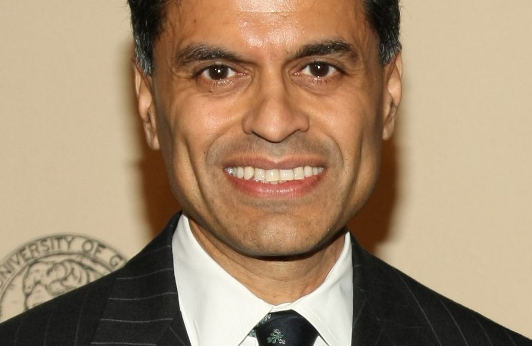 Fareed Zakaria in a dark suit at an awards event