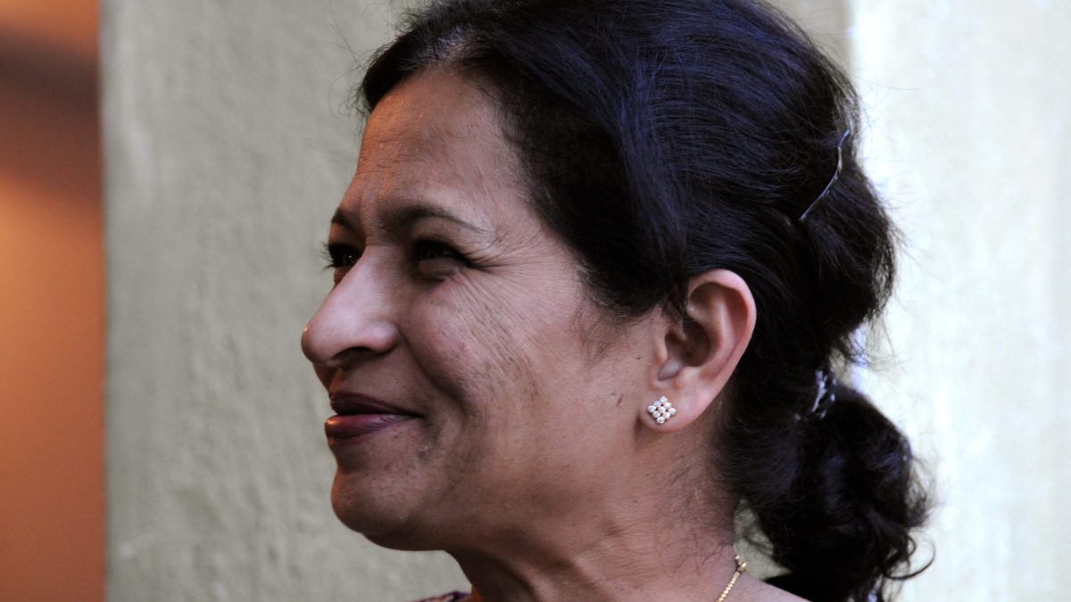 Gauri Lankesh in profile, smiling, with her hair tied back