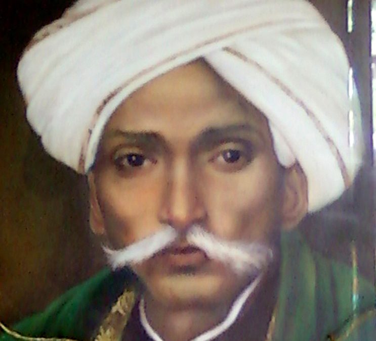 A painted portrait of Gurajada Apparao in a white turban with a large white moustache