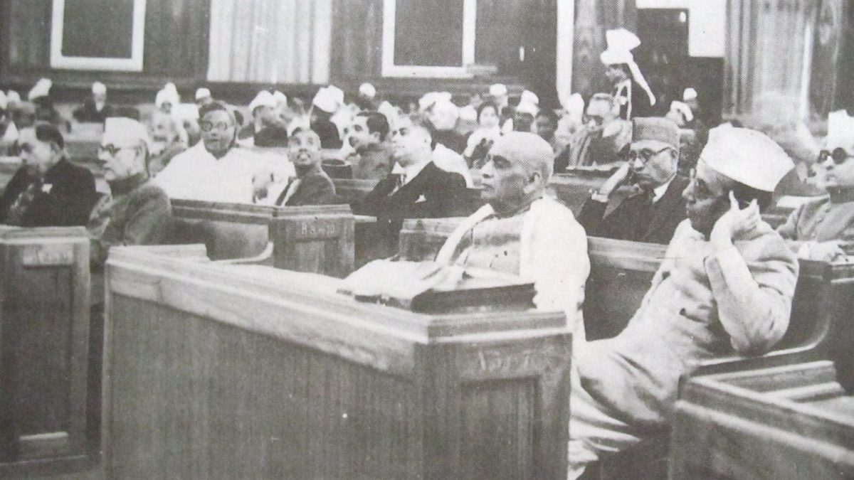 A black-and-white photograph of members seated at desks in the Constituent Assembly of India in December 1946