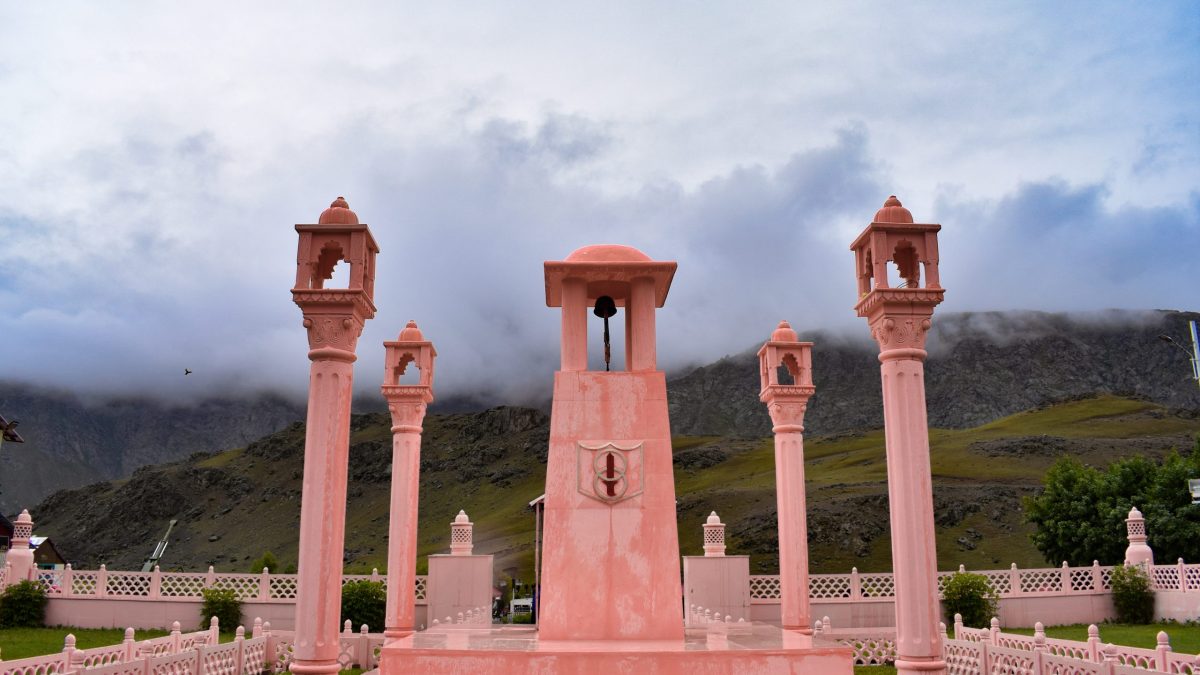 The pink sandstone Kargil War Memorial at Dras in Ladakh with mountains behind it