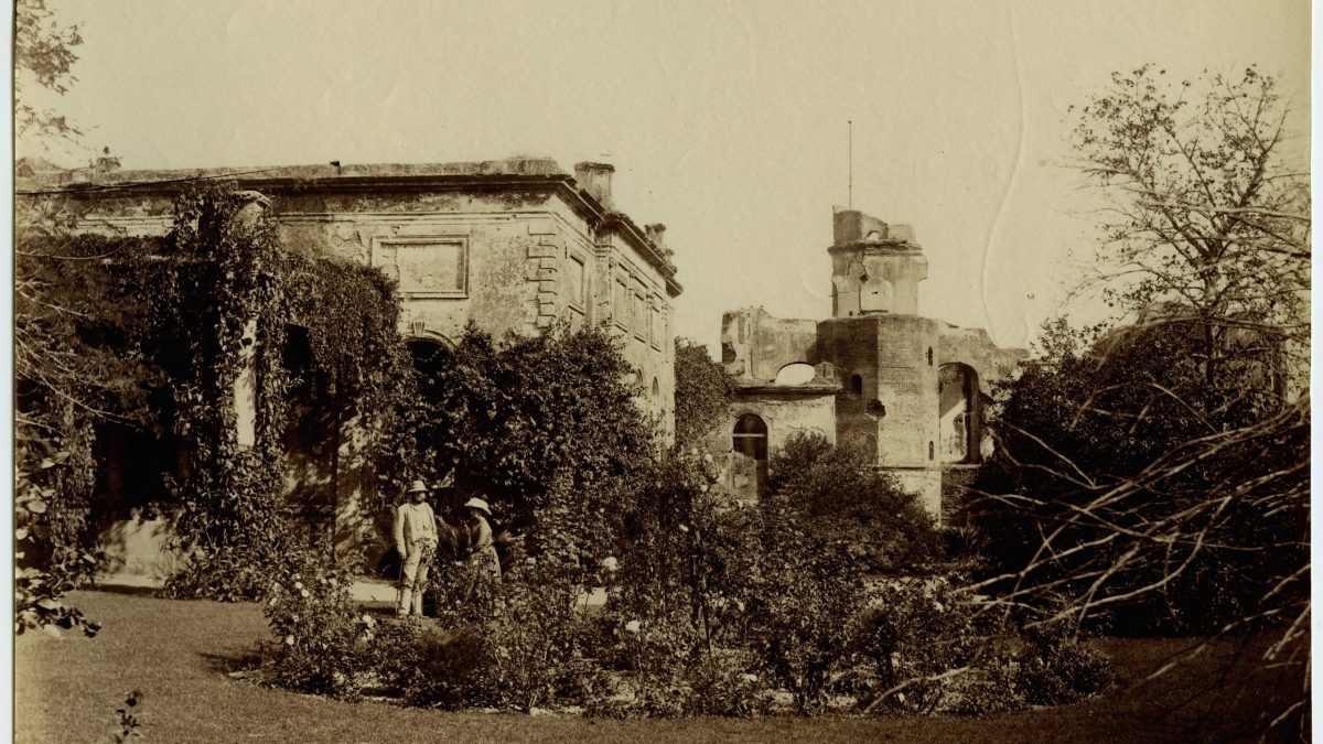 An old photograph of the ruined Residency buildings at Lucknow among trees