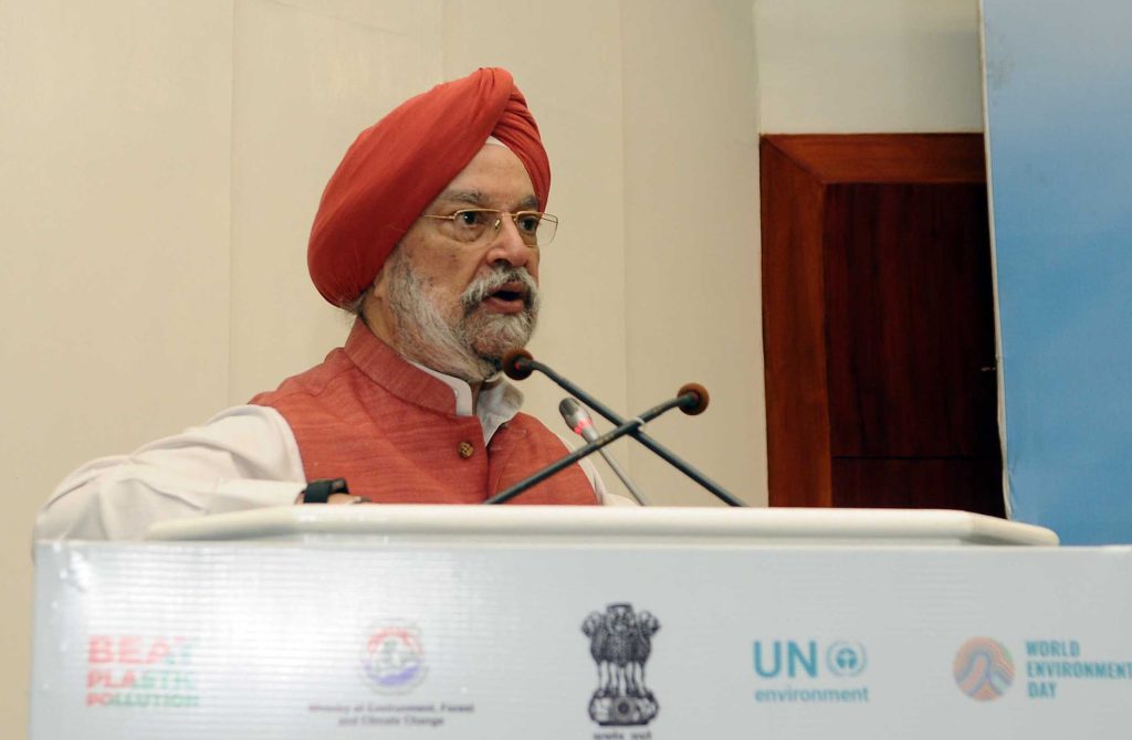 Hardeep Singh Puri in a red turban speaking at a lectern