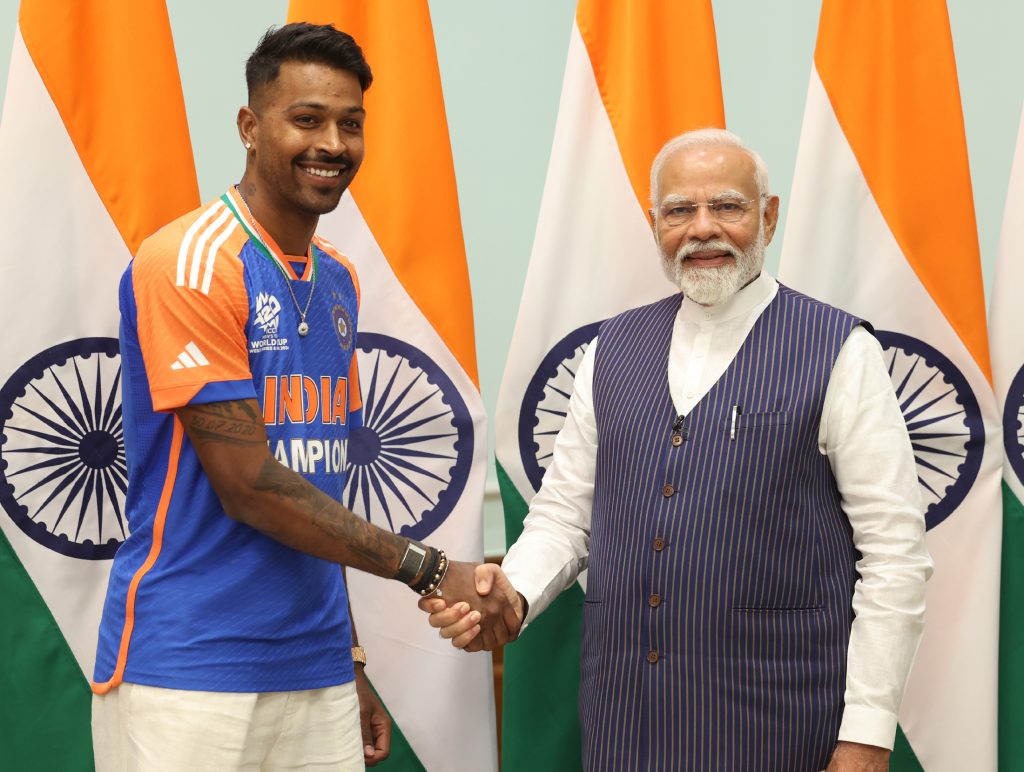 Hardik Pandya in India's champions jersey shaking hands with Prime Minister Narendra Modi