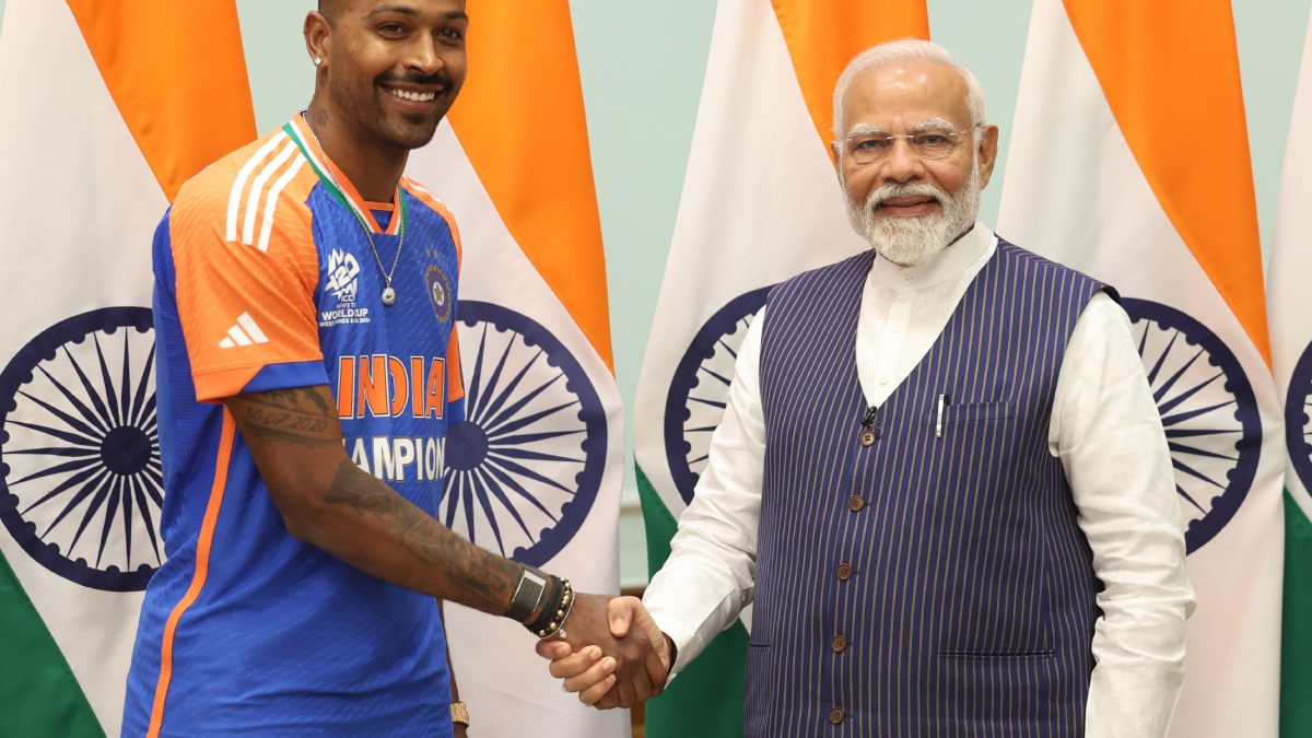 Hardik Pandya in India's champions jersey shaking hands with Prime Minister Narendra Modi