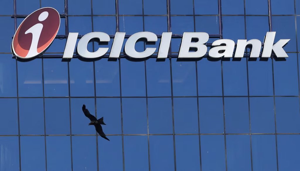 ICICI Bank logo on a blue glass office building with a bird flying below it