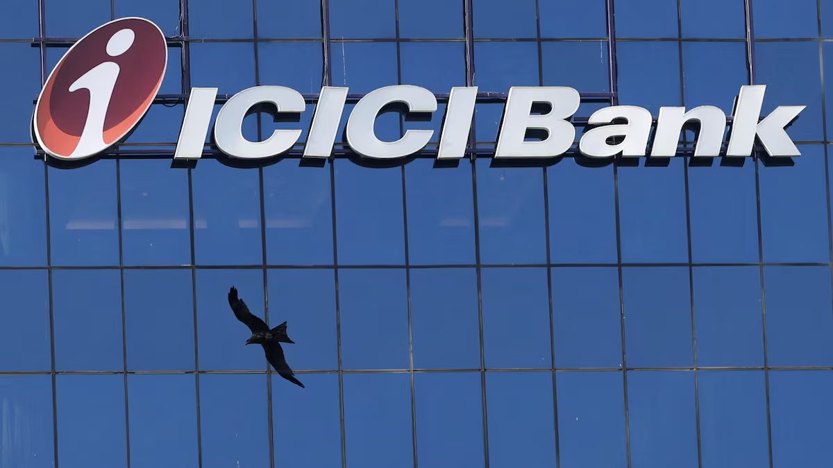 ICICI Bank logo on a blue glass office building with a bird flying below it