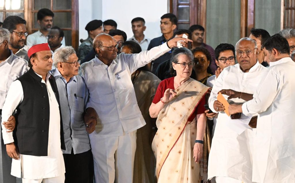 Opposition leaders from the INDIA bloc standing together outside a residence during a meeting in Delhi