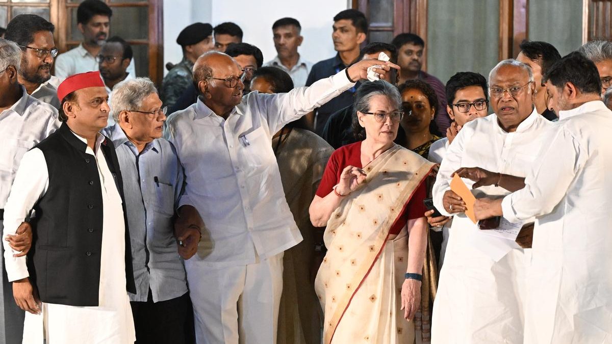 Opposition leaders from the INDIA bloc standing together outside a residence during a meeting in Delhi