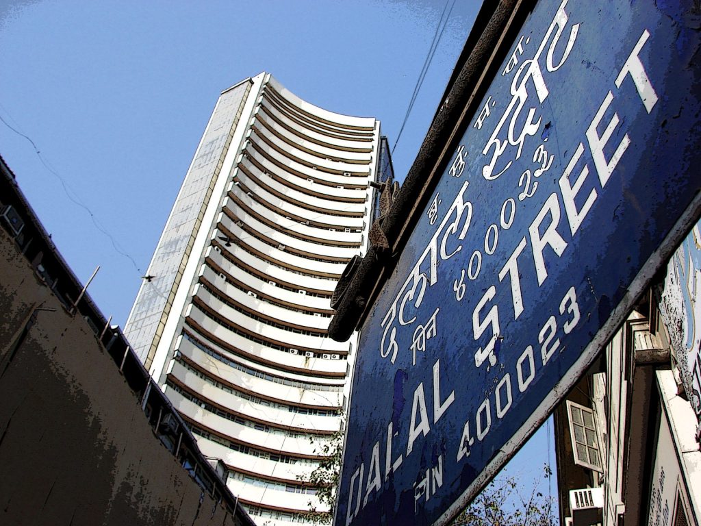 The BSE tower seen behind a Dalal Street signboard in Mumbai