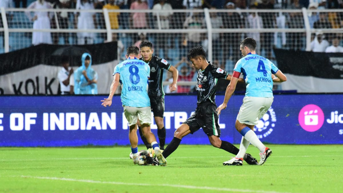 Footballers contesting the ball during an Indian Super League match