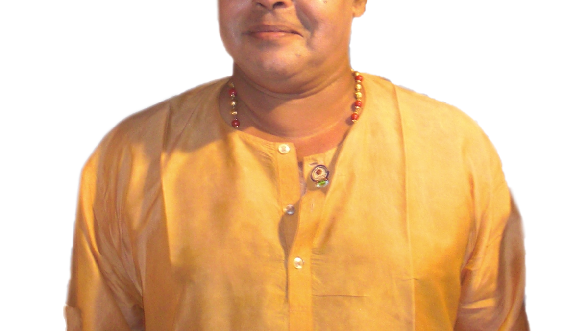 Innocent in glasses and a gold-coloured kurta, smiling