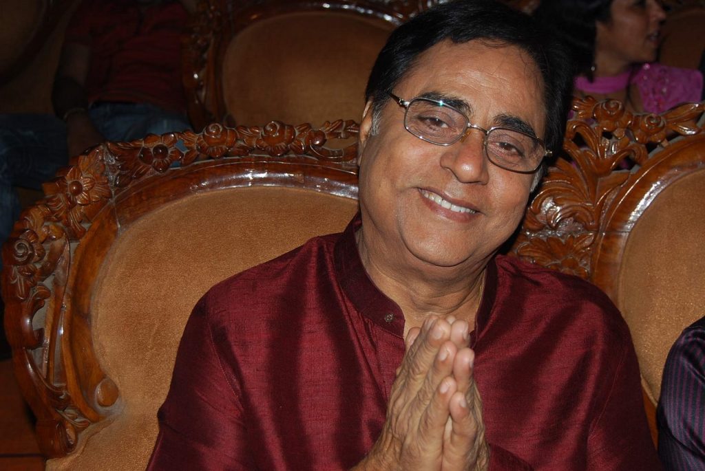Jagjit Singh in glasses and a maroon kurta smiling with folded hands