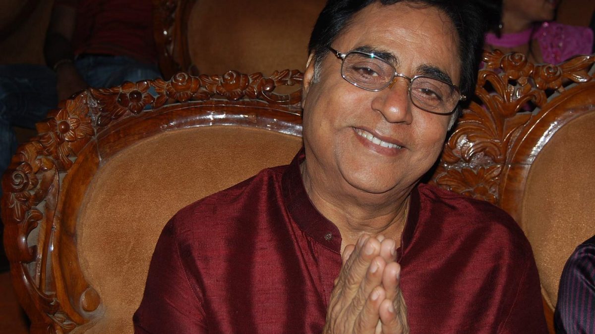 Jagjit Singh in glasses and a maroon kurta smiling with folded hands