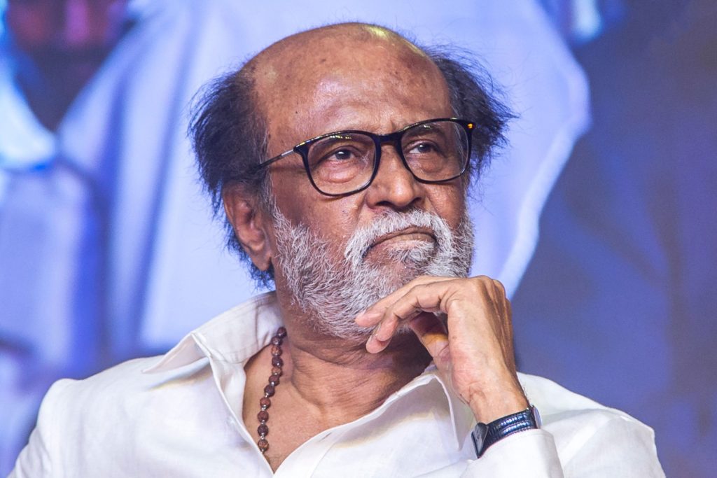 Rajinikanth in glasses, resting his chin on his hand