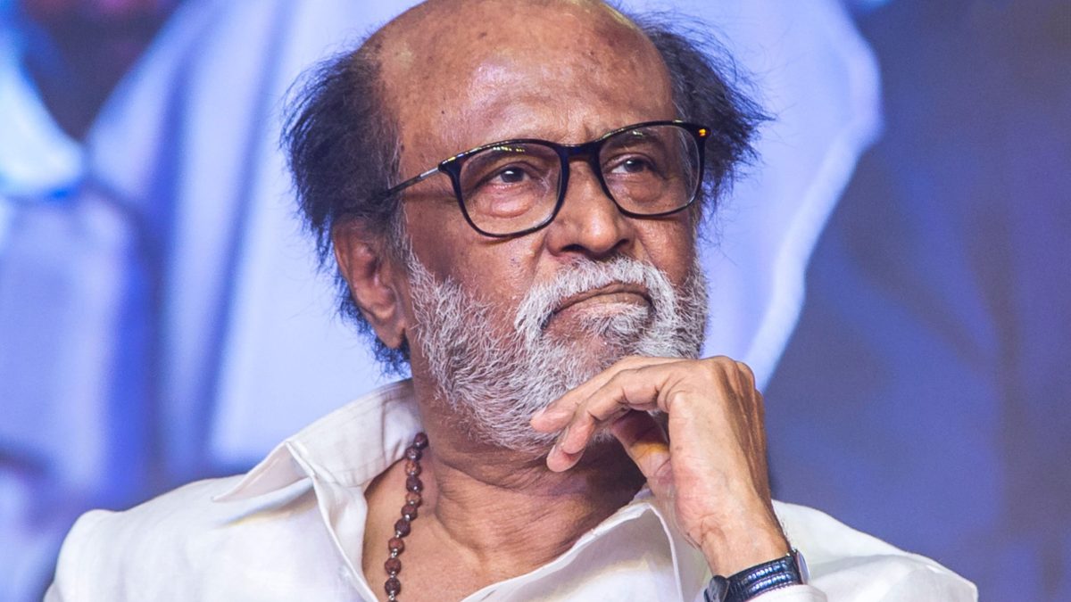 Rajinikanth in glasses, resting his chin on his hand